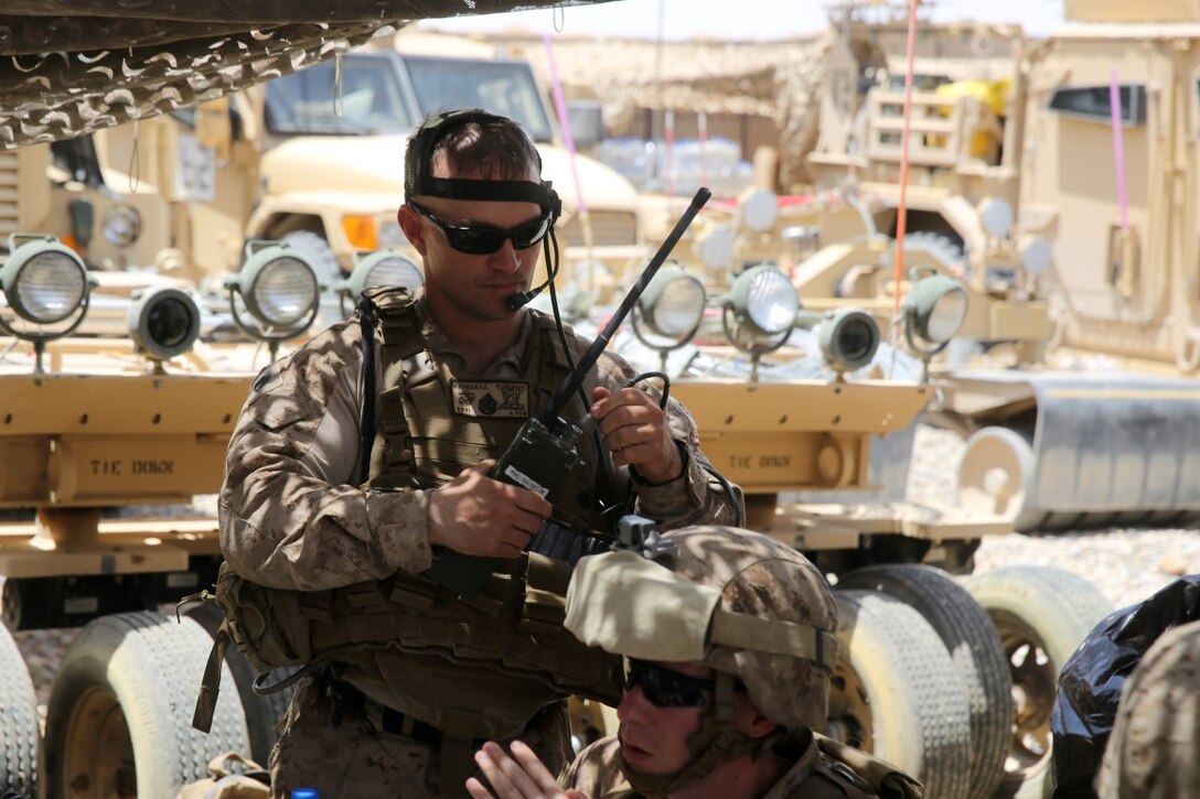 Staff Sgt. Paul Prograis, joint terminal attack controller, Headquarters and Service Company, 1st Battalion, 7th Marine Regiment, establishes radio connectivity during a mission in Helmand province, Afghanistan, June 13, 2014. Prograis, a native of Girard, Ill., along with a platoon of infantrymen, provided security at Patrol Base Ouellette, an Afghan National Army controlled-base, during the Afghanistan presidential runoff elections. While International Security Assistance Force stood ready to support as needed, the elections were entirely Afghan led and Afghan conducted.