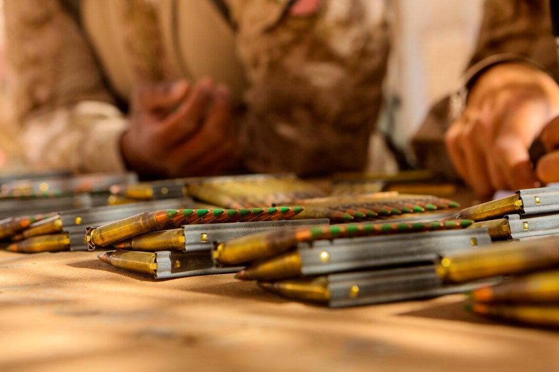 Marines with 1st Battalion, 2nd Marine Regiment, gather their ammunition prior to starting a combat marksmanship range held aboard Camp Leatherneck, Helmand province, Afghanistan, June 20, 2014. Ranges such as this one keep Marines on top of their shooting skills and give them the confidence they need while on a patrol. (U.S. Marine Corps photo by Cpl. Michael Dye/released)