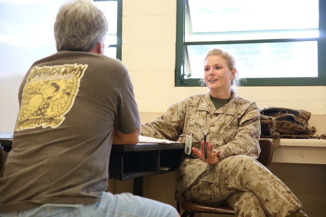 Navy Lt. Heather Sterk, a psychologist with 4th Medical Battalion, 4th Marine Logistics Group, speaks with a patient at the Kapaa Middle School site June 19, during Innovative Readiness Training exercise Tropic Care 2014. Kapaa Middle School is one of three main sites that patients can be seen for medical, dental and optometry care provided by the Department of Defense at no cost to the public, providing simultaneous military training for medical personnel.  