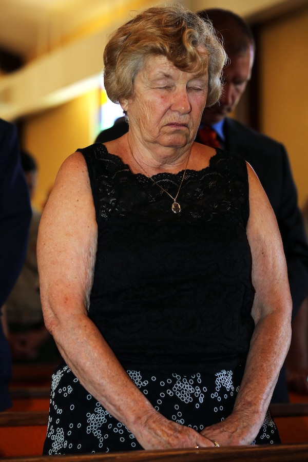 Elizabeth Smith joins a congregation of more than 100 Marines, Sailors and civilian friends and family in prayer during the rededication of the Caruso Chapel, at the School of Infantry-West, here, June 23.

The chapel was initially dedicated to Caruso in 1953 and he was awarded the Silver Star Medal in 1950 for shielding father Connie Griffin, a chaplain then assigned to the 7th Marine Division (reinforced), from enemy fire with his body during an ambush in the Korean War, Dec. 6, 1950.

“It’s terrific to be here this time since I missed the first one,” said Smith. Smith was unable to travel due to pregnancy during the chapel’s initial dedication. “The ceremony was stirring and it’s such an honor to be here. My husband made a tremendous sacrifice.”
