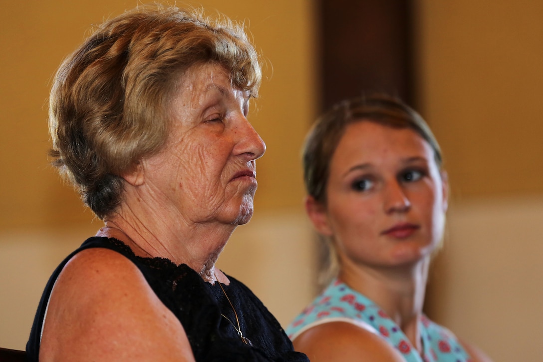 Elizabeth Smith weeps as she listens to her son, Daniel Caruso, share his warm feelings about his father, Sgt. Matthew Caruso, with a congregation of more than 100 Marines, sailors and civilian friends and family during the rededication of the Caruso Chapel, at the School of Infantry-West, here, June 23.

The chapel was initially dedicated to Caruso in 1953 and he was awarded the Silver Star Medal in 1950 for shielding father Connie Griffin, a chaplain then assigned to the 7th Marine Division (reinforced), from enemy fire with his body during an ambush in the Korean War, Dec. 6, 1950.

“He’s been a wonderful son and I’ve been very proud of him,” said Smith. “The ceremony was stirring and it’s such an honor to be here. My husband made a tremendous sacrifice.”
