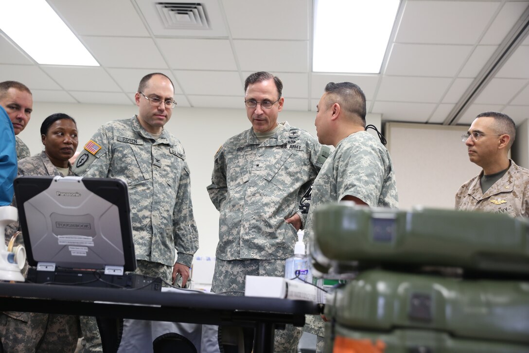 Army Brigadier General Daniel Dire, commanding general for 3rd Medical Command Deployment Support (Middle), tours the Kauai Community College site during Innovative Readiness Training exercise Tropic Care 2014 at Kauai, Hawaii. Each the three main sites and the mobile site provide care to potential patients that can be seen for medical, dental and optometry care provided by the Department of Defense at no cost to the public, providing simultaneous military training for medical personnel. TC14 also allows service members from each branch to combine their expertise in a joint-training environment.   