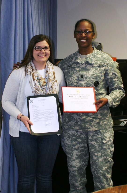 ALBUQUERQUE, N.M., -- Lt. Col. Antoinette Gant presents Jordan Martinez, office of counsel, a certificate honoring her as the District's Employee of the Quarter, May 12, 2014.