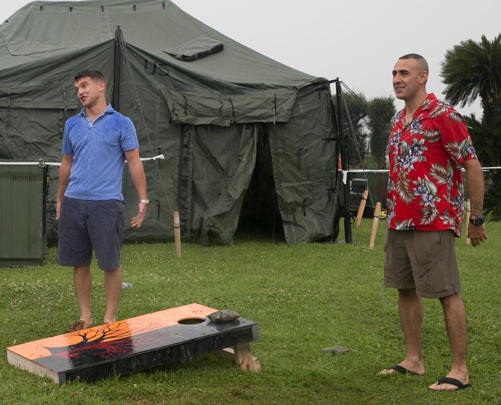 Sgt. Eric Chartier, left, and Sgt. Maj. Robert Tellez play “corn hole” during the 3rd Maintenance Battalion’s 3rd annual Summer Luau June 13 at the Hai Sai Center on Camp Kinser. The battalion is stationed at various installations across Okinawa, and the luau provided the opportunity for the battalion to come together to build camaraderie, according to Tellez. Chartier is a Somers, Connecticut, native and generator mechanic with 3rd Maintenance Battalion, Combat Logistics Regiment 35, 3rd Marine Logistics Group, III Marine Expeditionary Force. Tellez is a San Diego, California, native and sergeant major of the battalion. 