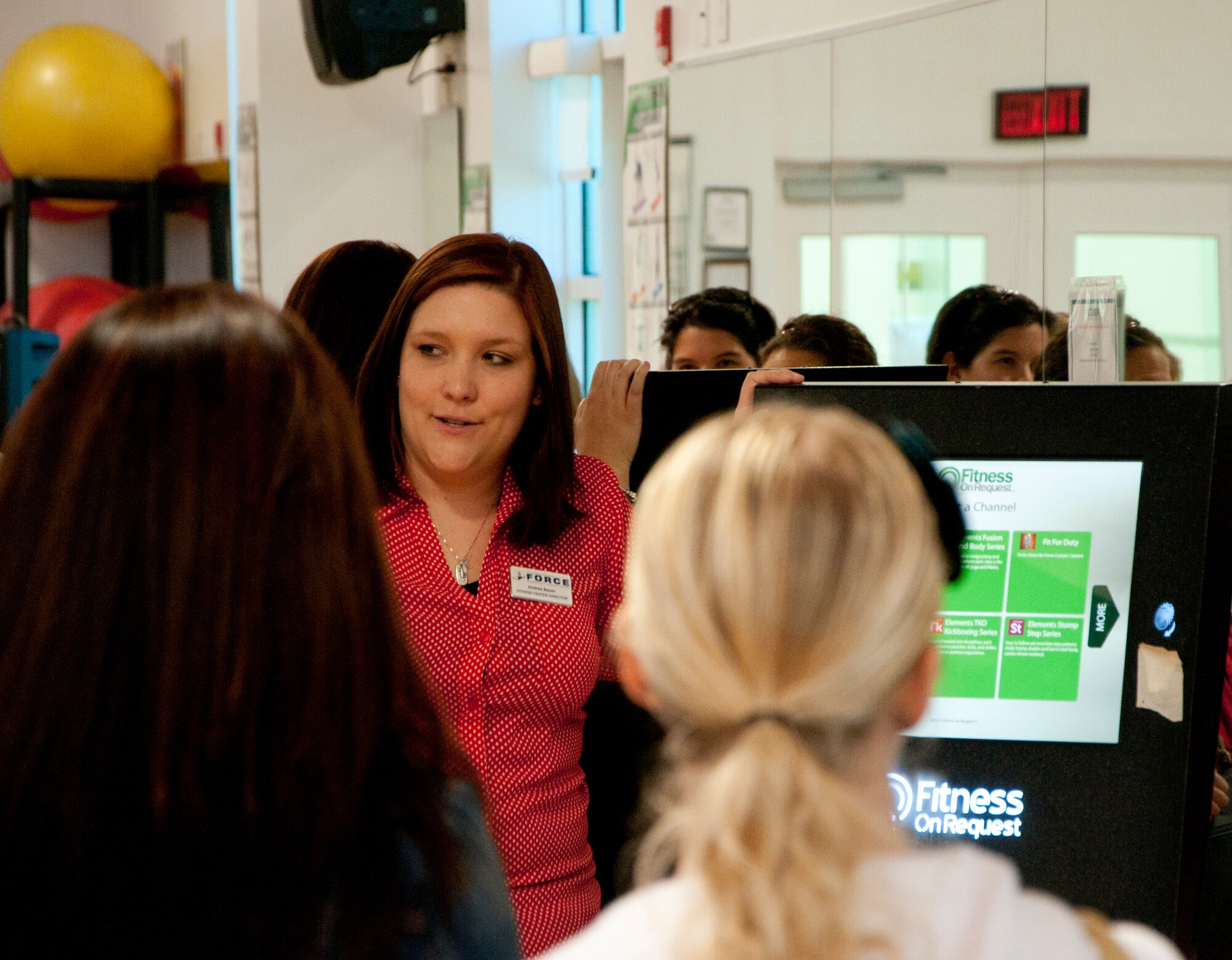 Andrea Bauer, 90th Force Support Squadron fitness center director, introduces new F.E. Warren spouses to the Freedom Hall Fitness Center and all it has to offer June 19, 2014. The fitness center is one of several stops the spouses made on the Military Spouse Orientation Tour hosted by the Airmen & Family Readiness Center. (U.S. Air Force photo by Airman 1st Class Jason Wiese)
