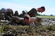 Team Malmstrom members from the 341st Security Forces Group work in unison to knock out as many push-ups as possible during the team pain station of the 3rd Annual Aces Cop Combat Challenge at Malmstrom Air Force Base on June 20. In total, there were more than 23 stations for security forces members to complete throughout the day before tallying up the points to determine the competition’s winning team. (U.S. Air Force photo/Airman 1st Class Collin Schmidt)