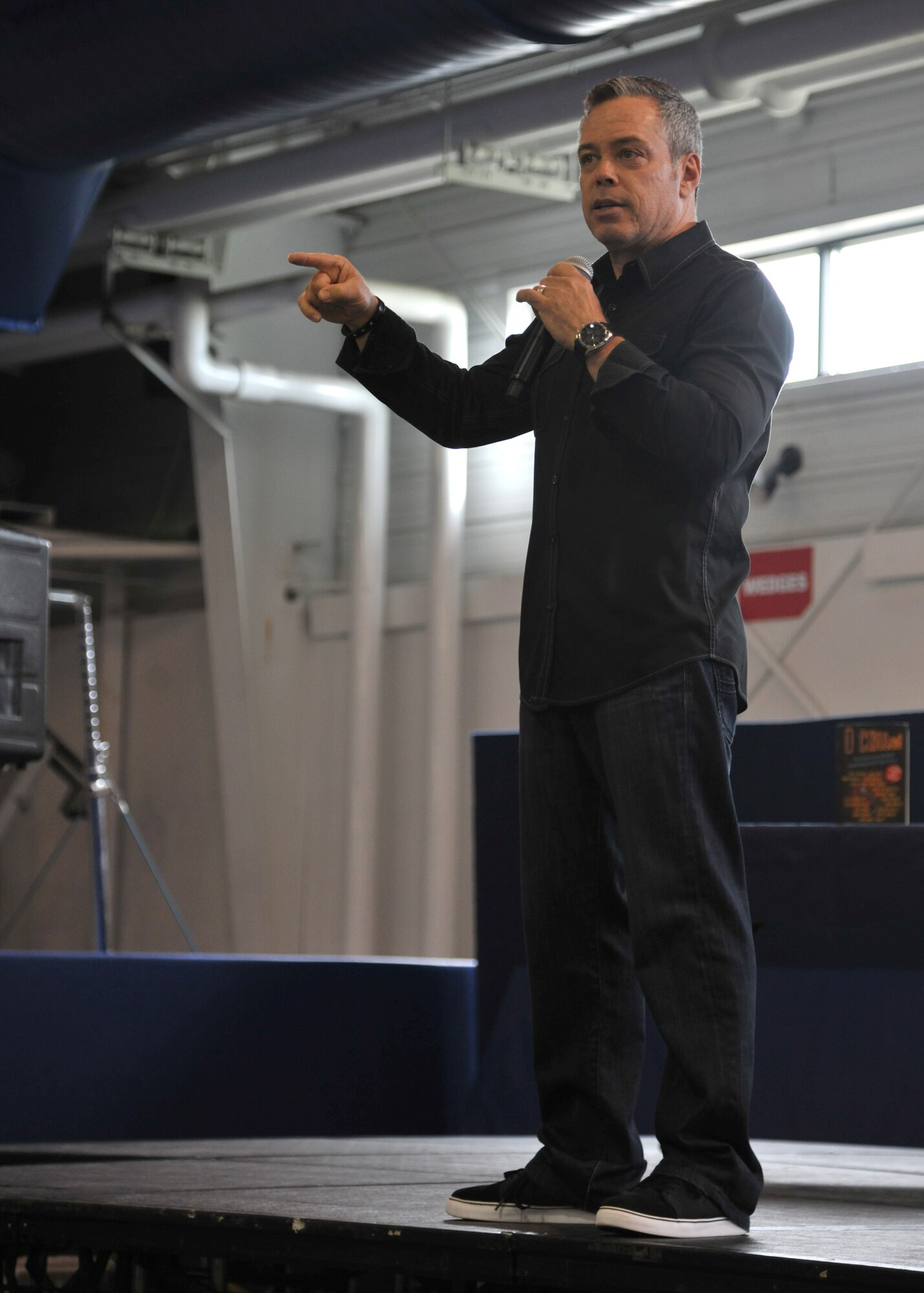Bernie McGrenahan, stand–up comedian, speaks about his personal life of how high-risk drinking affected him and his family June 20, 2014, at Liberty Square on Grand Forks Air Force Base, N.D. McGrenahan talked about his alcohol-related problems, dealing with his brother’s suicide and how he is now committed to motivate service members to identify the warning signs of alcohol and drug dependency. (U.S. Air Force photo/Senior Airman Xavier Navarro)