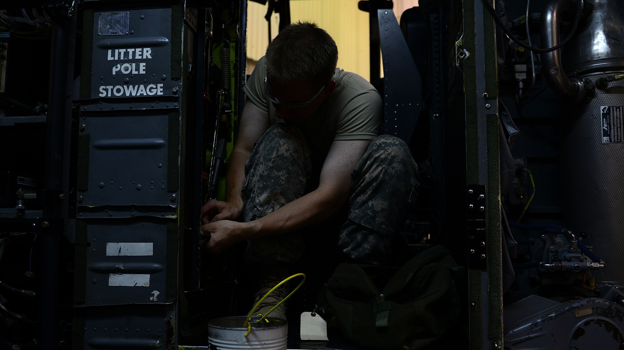 U.S. Army Pvt. Austin Byrd, 128th Aviation Brigade medium helicopter repair Advanced Individual Training student, troubleshoots and repairs a piece of equipment in the Chinook CH-47 training aircraft at Fort Eustis, Va., June 17, 2014. Students gain practical knowledge through these instructor-supervised exercises. (U.S. Air Force photo by Airman 1st Class Kimberly Nagle/Released) 