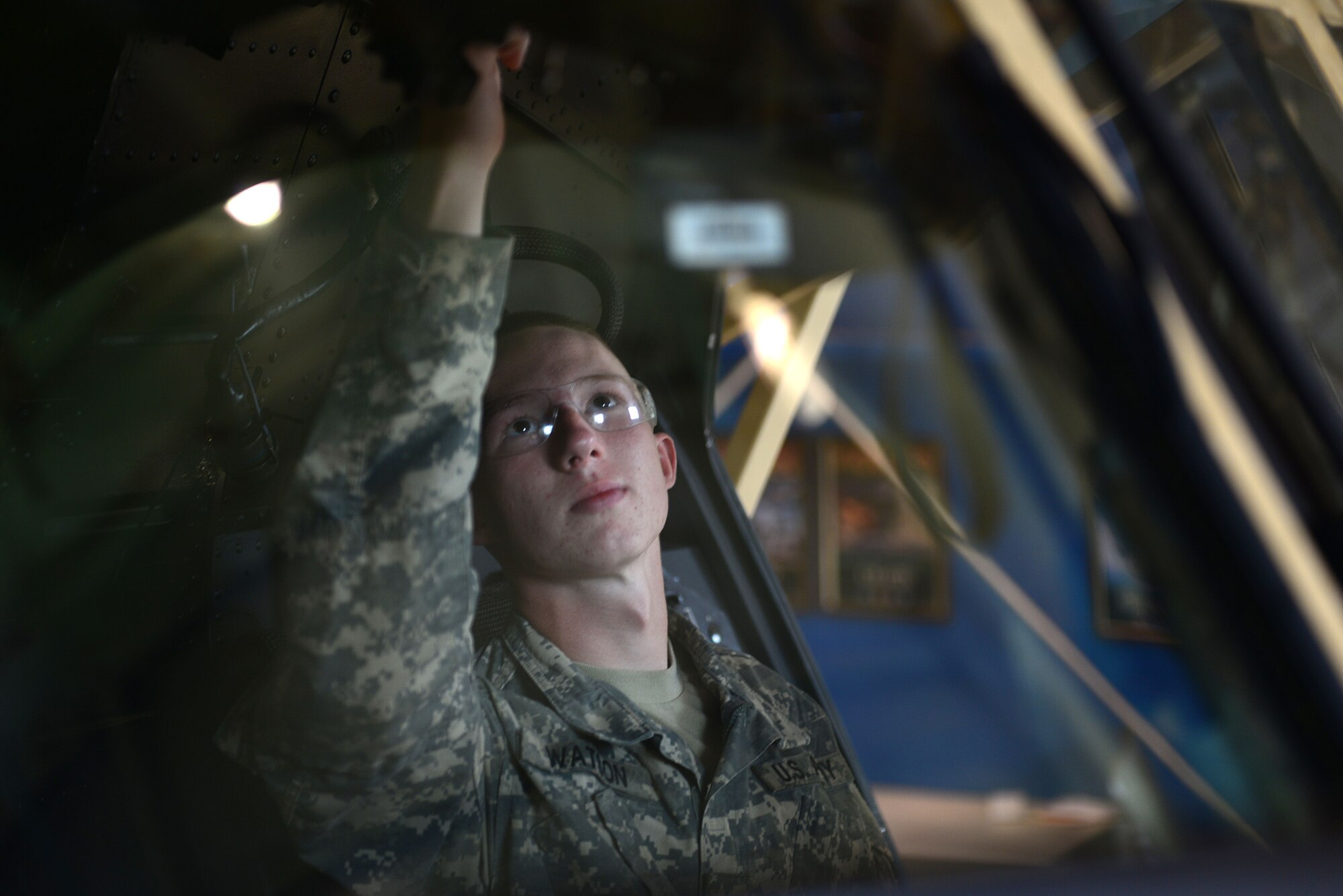 U.S. Army Pvt. Jesse Watson, F Company 1st Battalion, 222nd, 128th Aviation Brigade Chinook maintainer Advanced Individual Training student, performs checks on the common avionics architecture system in a Chinook CH-47 training aircraft at Fort Eustis, Va., June 17, 2014. Watson said he finds benefit in the program’s technological instruction and has learned a great deal from his instructors’ efforts. (U.S. Air Force photo by Airman 1st Class Kimberly Nagle/Released)
