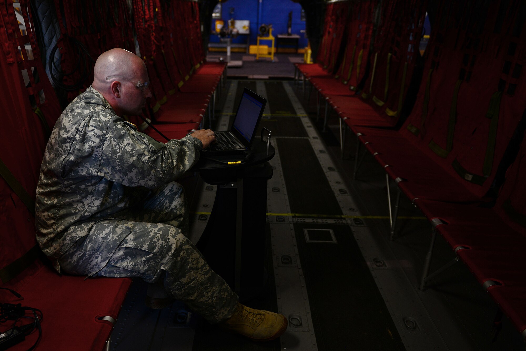 U.S. Army Staff Sgt. Joseph Batts, A Company, 2nd Battalion, 210th Aviation Regiment medium repair supervisor course instructor, sets up a scenario for students to troubleshoot at Fort Eustis, Va., June 17, 2014. Instructors and students use multiple technological advances in the training as a way to provide more efficient instruction. (U.S. Air Force photo by Airman 1st Class Kimberly Nagle/Released)