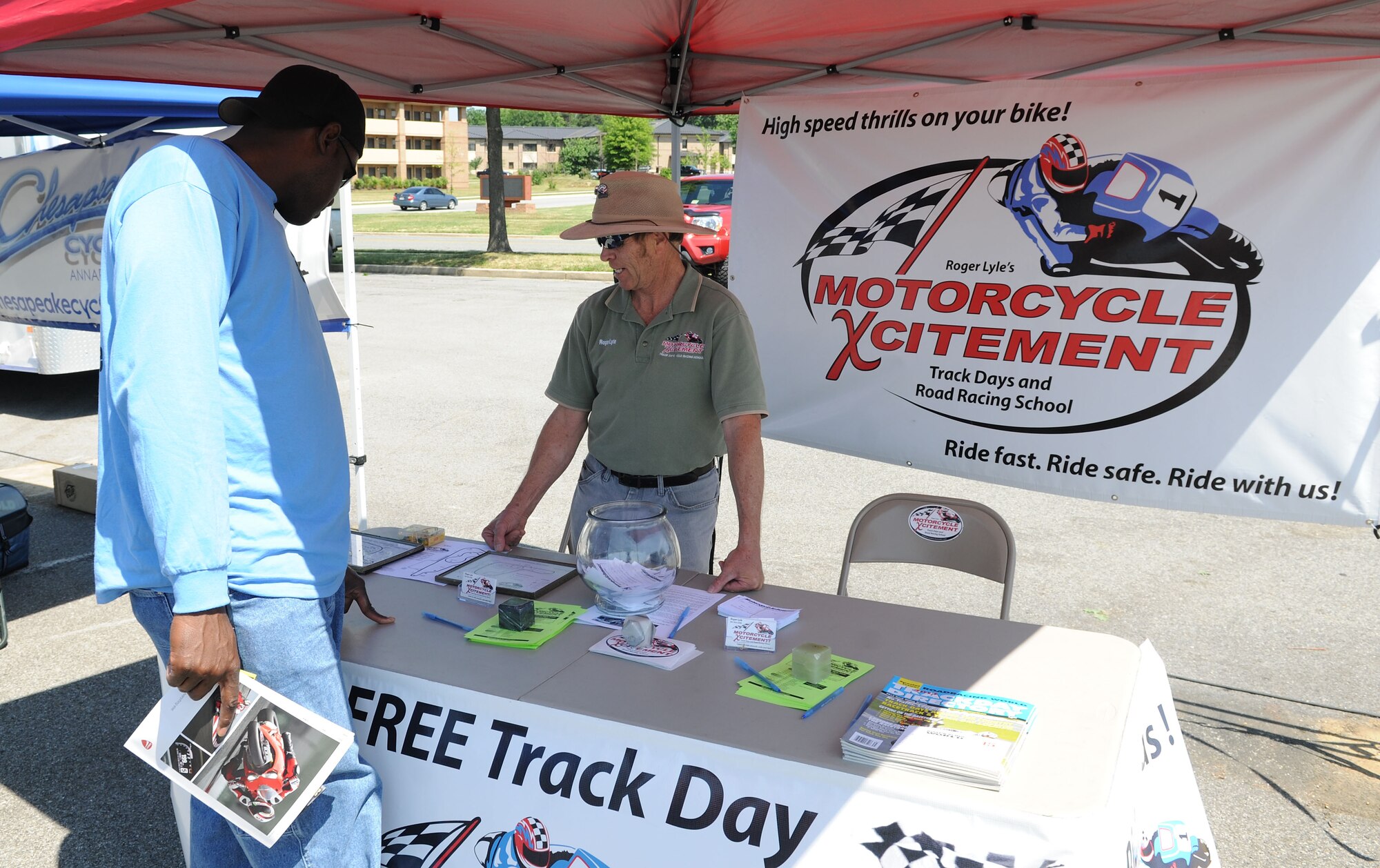 Senior Master Sgt. Clay Staten (left) speaks with Roger Lyle during the 4th Annual Motorcycle Safety Day on Joint Base Andrews, Md., June 20, 2014. Staten is the 11th Civil Engineering Squadron operations engineering superintendent and Lyle is the Motorcycle Xcitement owner. (U.S. Air Force photo/Airman 1st Class Ryan J. Sonnier)