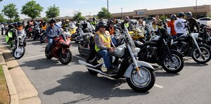 Team Andrews members prepare for the escorted off-base motorcycle ride during the 4th Annual Motorcycle Safety Day on Joint Base Andrews, Md., June 20, 2014. The event provided demonstrations and safety tips to help reduce accidents among riders. (U.S. Air Force photo/Airman 1st Class Ryan J. Sonnier)
