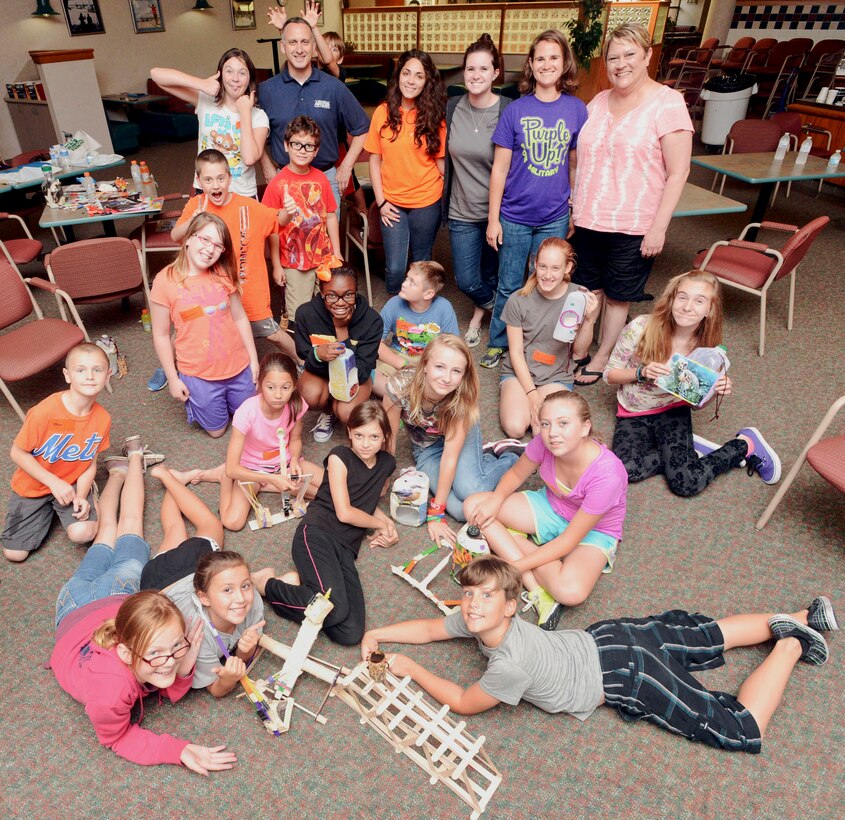 Master Sgt. David Tanner, a family support technician for the 137th Air Refueling Wing; Jennifer Lain, the Airmen and Family Readiness program manager for the 137th ARW; and Oklahoma State graduate students Carrie Winslett, Heavin Taylor and Nichole Pittman pose with a group of children participating in Oklahoma Operation Military Kids June 19, 2014, at Will Rogers Air National Guard Base, Okla.  The three-day camp is designed to develop leadership and team-building skills through exercises and competitions.
(U.S. Air Force photo by Airman 1st Class Tyler Woodward)