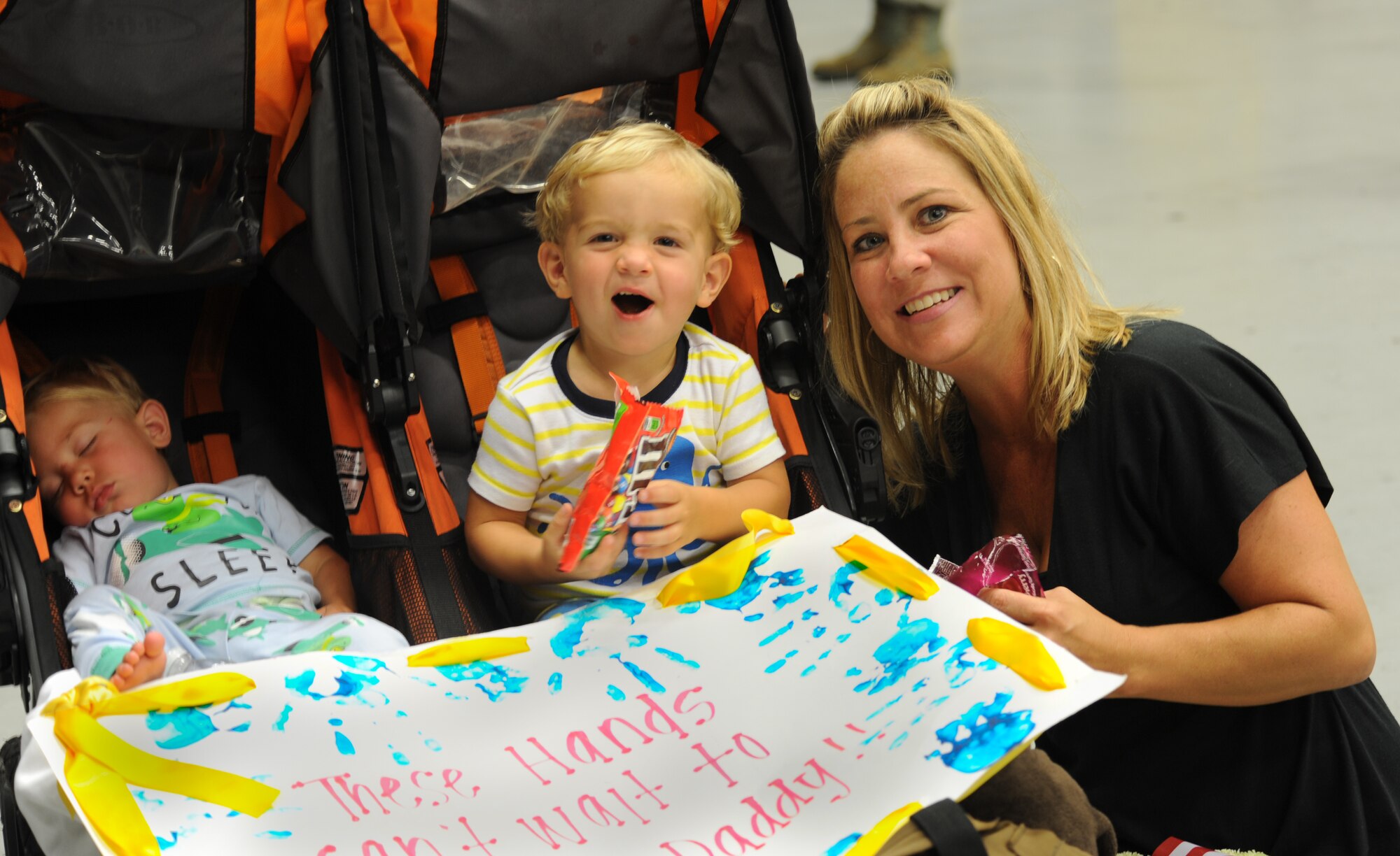 Master Sgt. Jeremy Hobb’s family awaits his arrival from deployment during Operation Homecoming at Hurlburt Field, Fla., June 21, 2014. Hobbs is a radio operator assigned to the 14th Weapons Squadron. (U.S. Air Force photo/Staff Sgt. Melanie Holochwost)