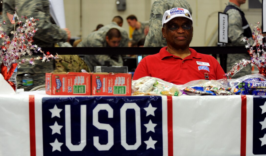 Robert Weaver, USO volunteer, supports Operation Homecoming at Hurlburt Field, Fla., June 21, 2014. Weaver handed out free drinks and snacks to returning deployers and their family members during the event. (U.S. Air Force photo/Staff Sgt. Melanie Holochwost)