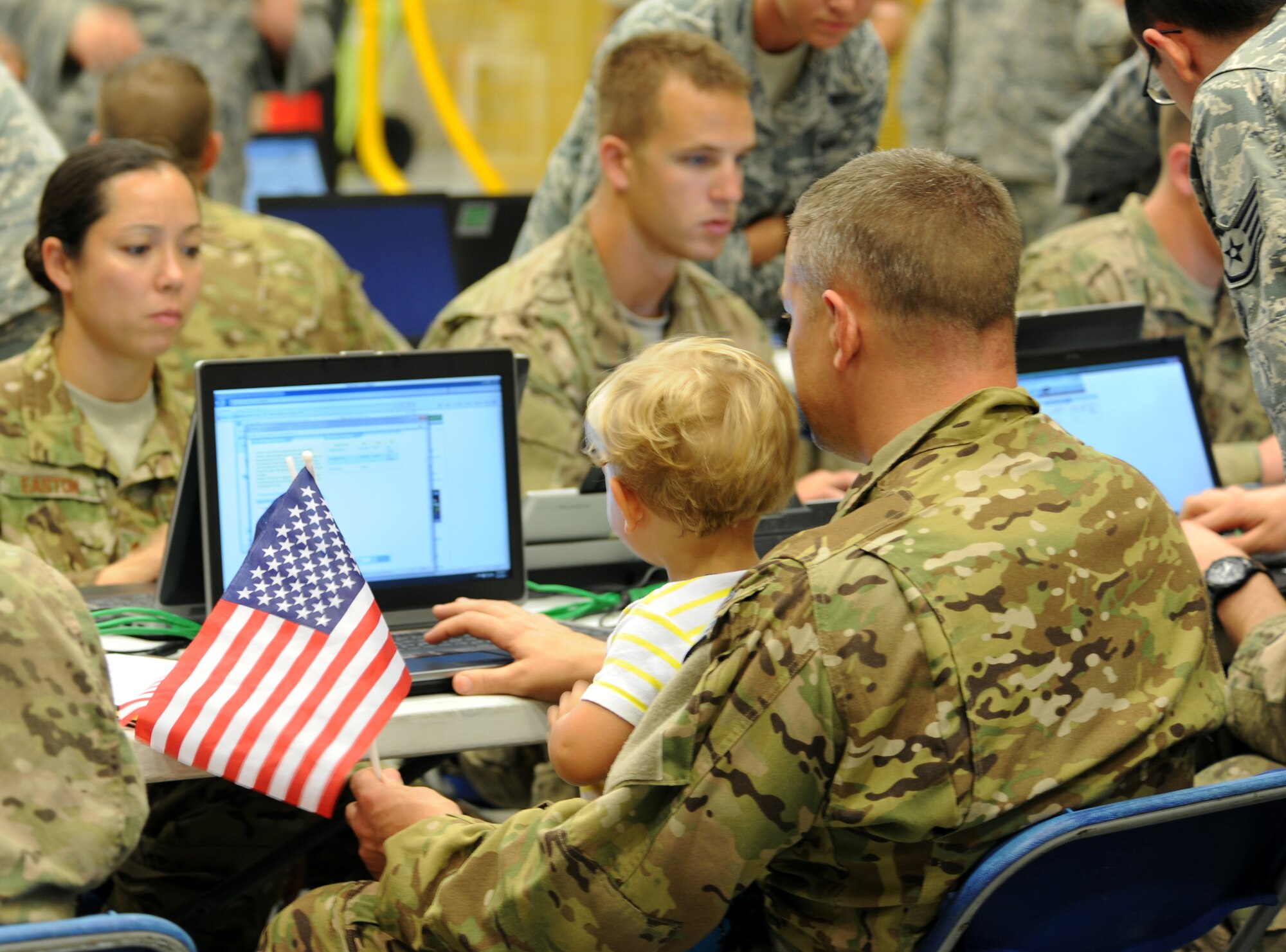 Returning deployers fill out paperwork during Operation Homecoming at Hurlburt Field, Fla., June 21, 2014. Friends and family members gathered at the 15th Aircraft Maintenance Unit hangar to welcome home their loved ones from their deployment. (U.S. Air Force photo/Staff Sgt. Melanie Holochwost)