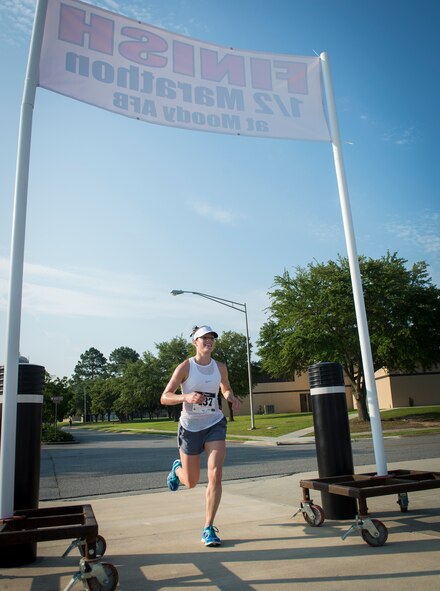U.S. Air Force Capt. Meredith Kirchoff finishes a half marathon at Moody Air Force Base, Ga., June 21, 2014. Nearly 150 runners participated in the 10K run and half marathon. (U.S. Air Force photo by Senior Airman Jarrod Grammel/Released)
