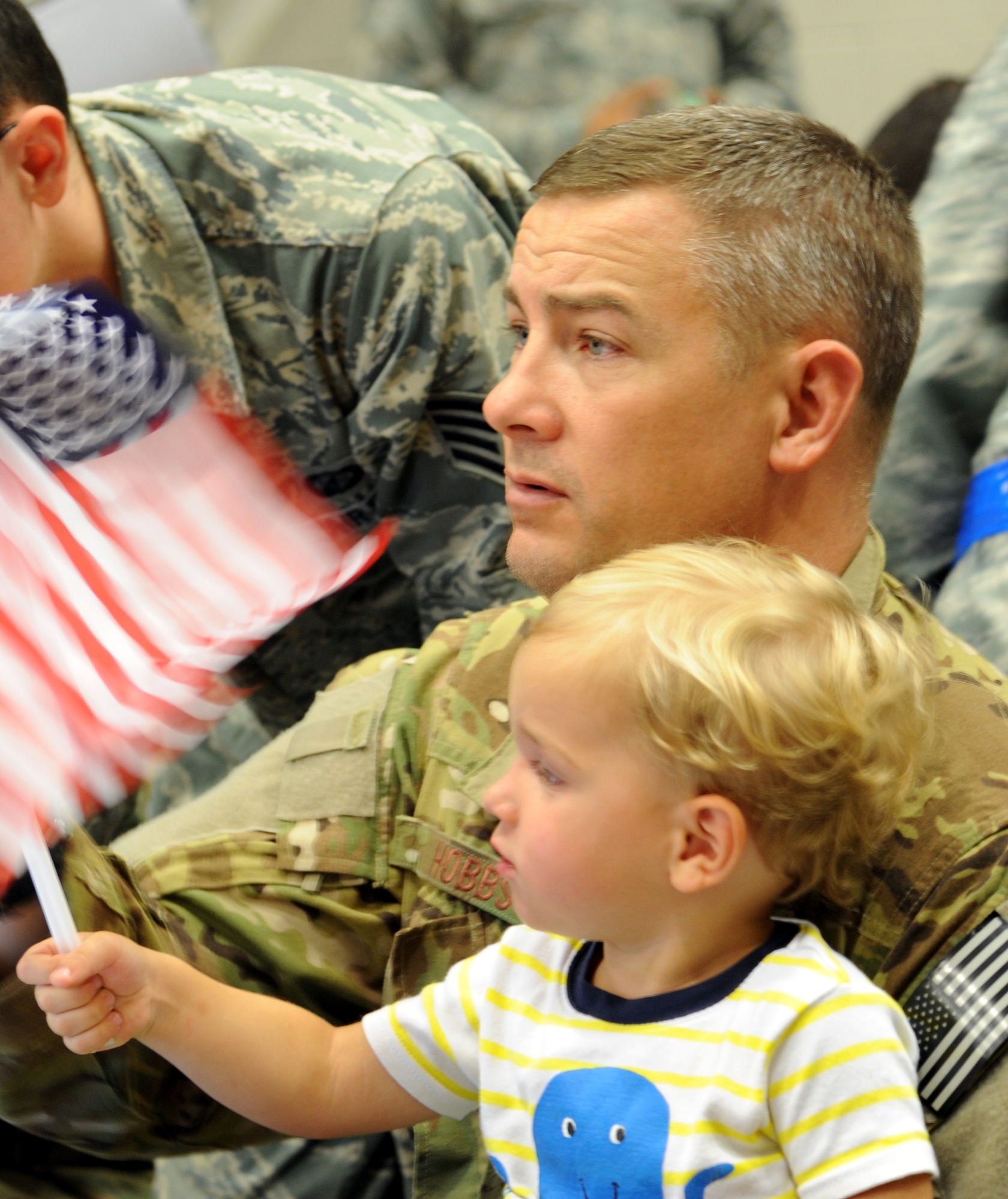Master Sgt. Jeremy Hobbs, 14th Weapons Squadron radio operator, holds his son, Landon, 2, during Operation Homecoming at Hurlburt Field, Fla., June 21, 2014.  Friends and family members gathered at the 15th Aircraft Maintenance Unit hangar to welcome home their loved ones from a deployment. (U.S. Air Force photo/Staff Sgt. Melanie Holochwost)