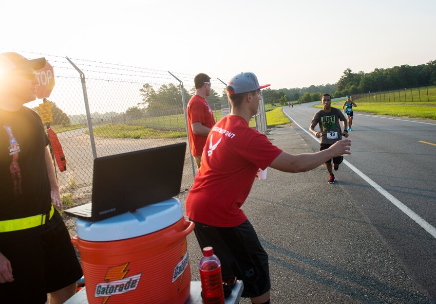 Airman Leadership School students work a water station during a 10K run and half marathon at Moody Air Force Base, Ga., June 21, 2014. Event organizers said safety was a top priority and made sure there were enough water stations for runners. (U.S. Air Force photo by Senior Airman Jarrod Grammel/Released)
