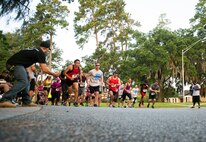 Runners take off from the start of a 10K run at Moody Air Force Base, Ga., June 21, 2014. The 10K was held in conjunction with Moody’s first-ever half marathon. (U.S. Air Force photo by Senior Airman Jarrod Grammel/Released)
