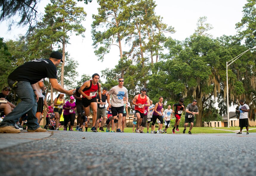 Runners take off from the start of a 10K run at Moody Air Force Base, Ga., June 21, 2014. The 10K was held in conjunction with Moody’s first-ever half marathon. (U.S. Air Force photo by Senior Airman Jarrod Grammel/Released)
