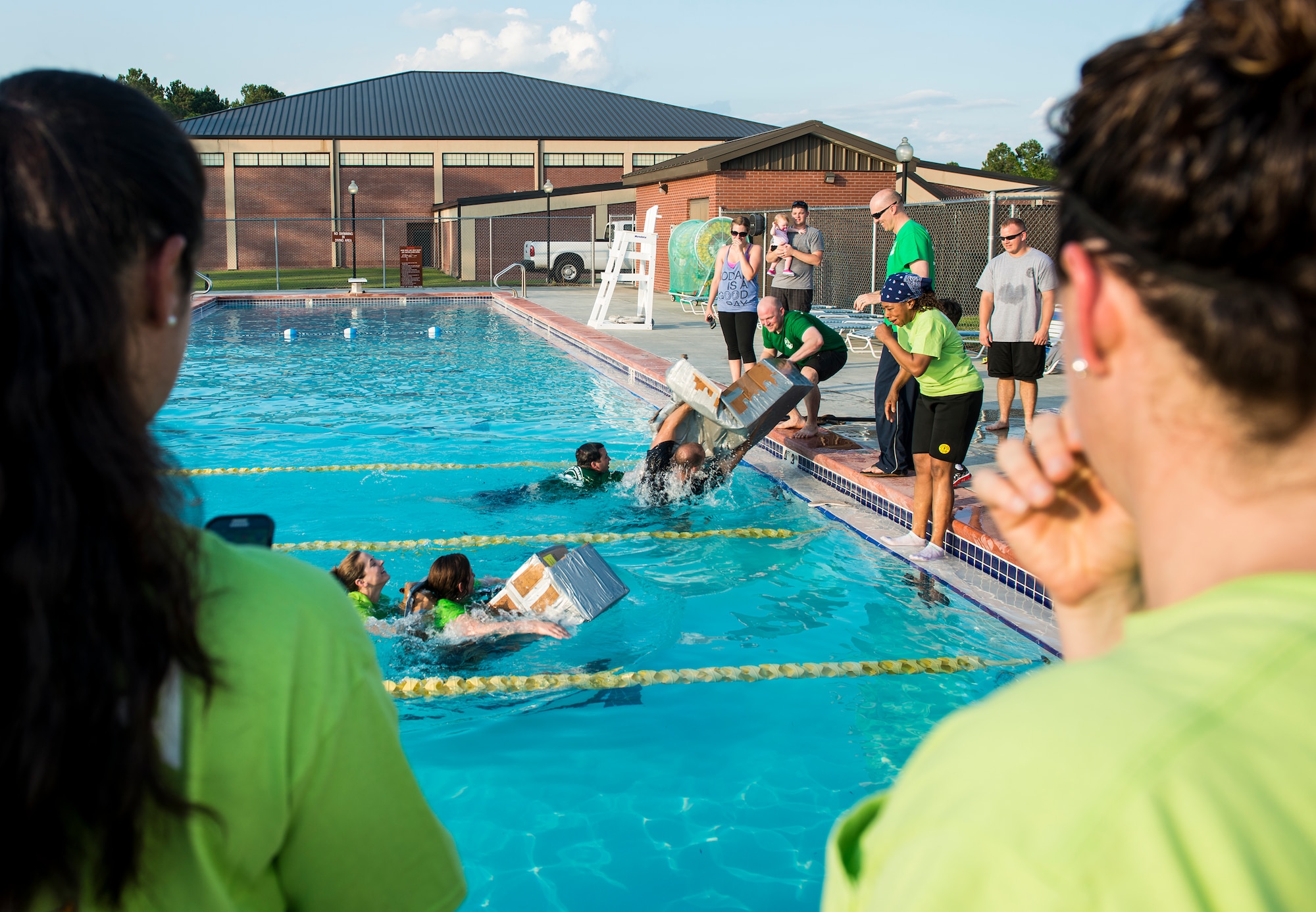 Participants of the 2014 Build a Boat competition watch as racers reach the finish line at Moody Air Force Base, Ga., June 19, 2014. The 41st Rescue Squadron narrowly won the race, beating their competition by only a few feet. (U.S. Air Force photo by Senior Airman Douglas Ellis/Released)

