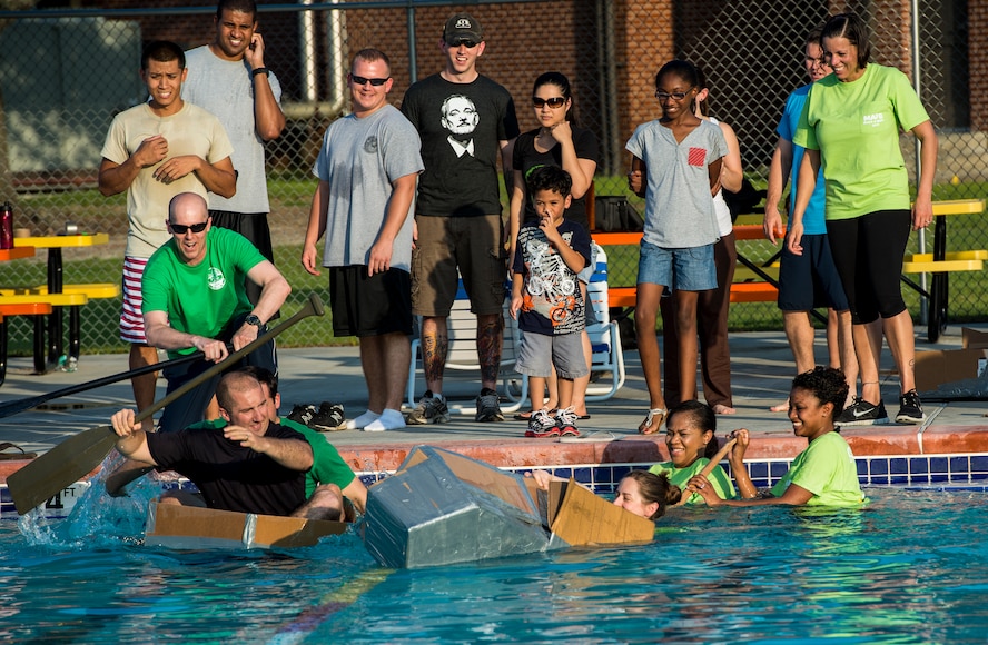 Competitors race across the base pool using team-made cardboard boats during the 2014 Build a Boat competition at Moody Air Force Base, Ga., June 19, 2014. The 41st Rescue Squadron team won the race and was one of only a few teams to complete the entire race. (U.S. Air Force photo by Senior Airman Douglas Ellis/Released)
