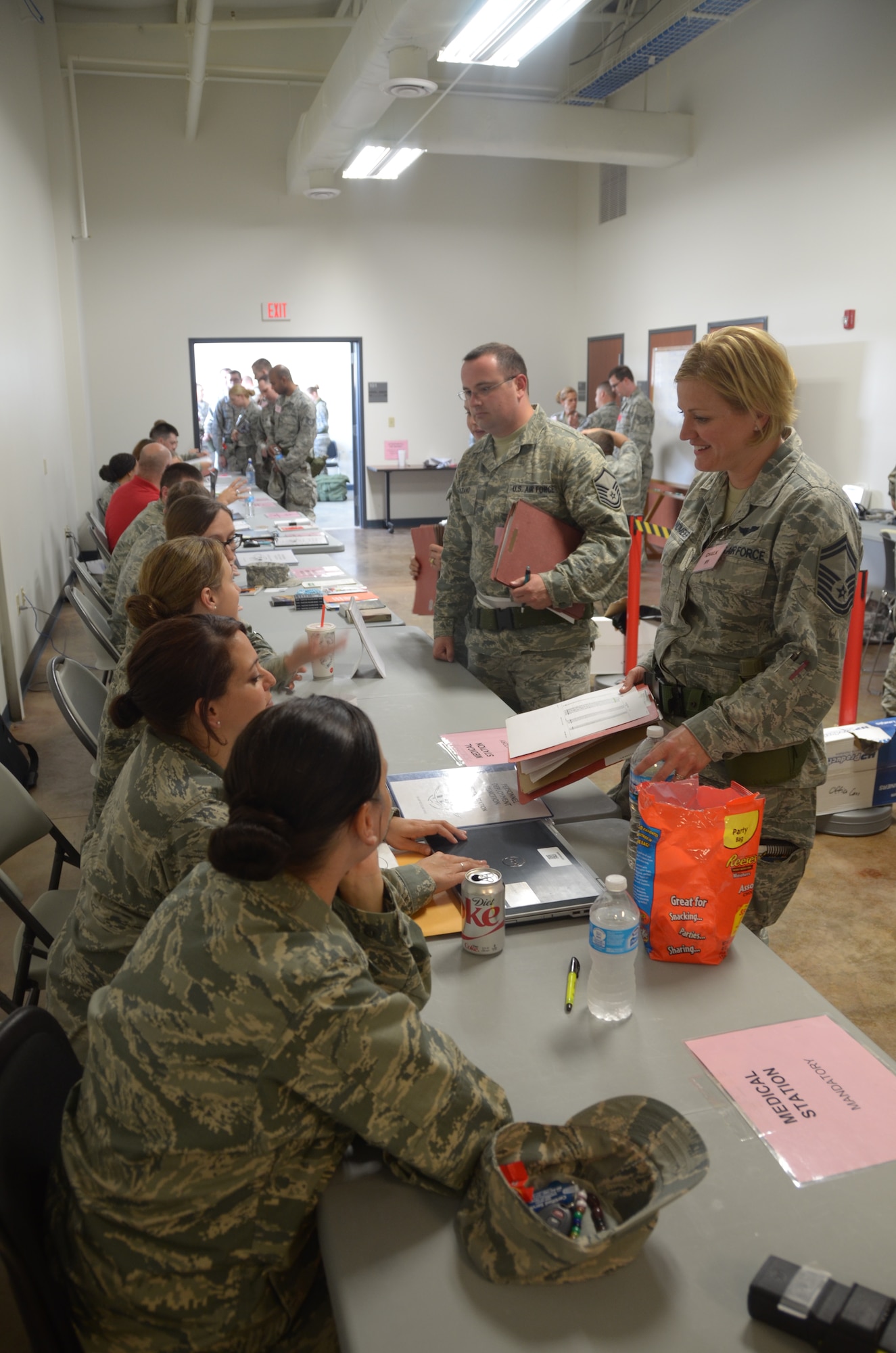 Senior Master Sgt. Heather Braundmeier, the Health Promotion manager for the 126th Medical Group, goes over medical questions while in the simulated processing line during the 8010 nuclear mission exercise conducted on Scott Air Force Base, Ill., June 7, 2014. The 126 ARW, an Illinois Air National Guard unit stationed at Scott Air Force Base, Ill., supports USSTRATCOM's nuclear global strike and strategic deterrence missions through aerial refueling with the KC-135R Stratotanker to deter regional and strategic threats from adversaries with ground warfare capabilities. (Air National Guard photo by Senior Airman Elise Stout)