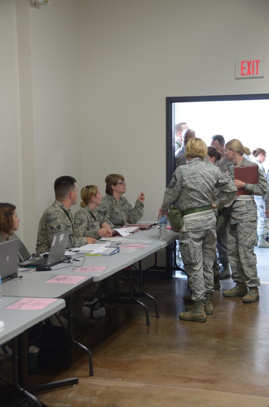 Members of the 126th Air Refueling Wing line up at the start of the processing line during the 8010 nuclear mission exercise conducted on Scott Air Force Base, Ill., June 7, 2014. The 126 ARW, an Illinois Air National Guard unit stationed at Scott Air Force Base, Ill., supports USSTRATCOM's nuclear global strike and strategic deterrence missions through aerial refueling with the KC-135R Stratotanker to deter regional and strategic threats from adversaries with ground warfare capabilities. (Air National Guard photo by Senior Airman Elise Stout)