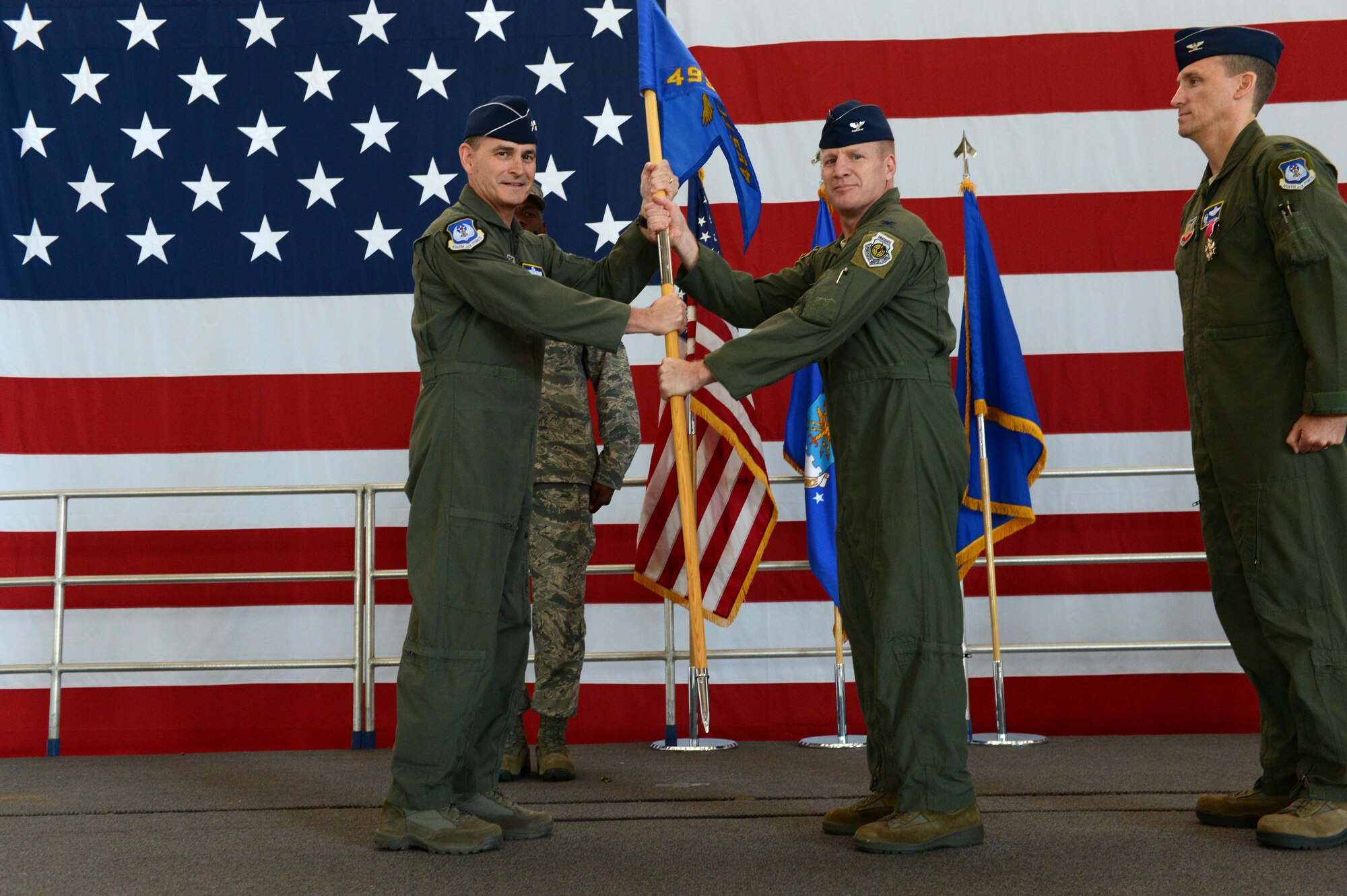 U.S. Air Force Col. James McCune, 495th Fighter Group commander, receives the 495th FG guidon from Maj. Gen. Jake Polumbo, Ninth Air Force commander, as he assumes command of the group during a change of command ceremony at Shaw Air Force Base, S.C., June 20, 2014. Outgoing and incoming commanders exchange unit guidons to symbolize relinquishment and assumption of command. (U.S. Air Force photo by Airman 1st class Jensen Stidham/Released)