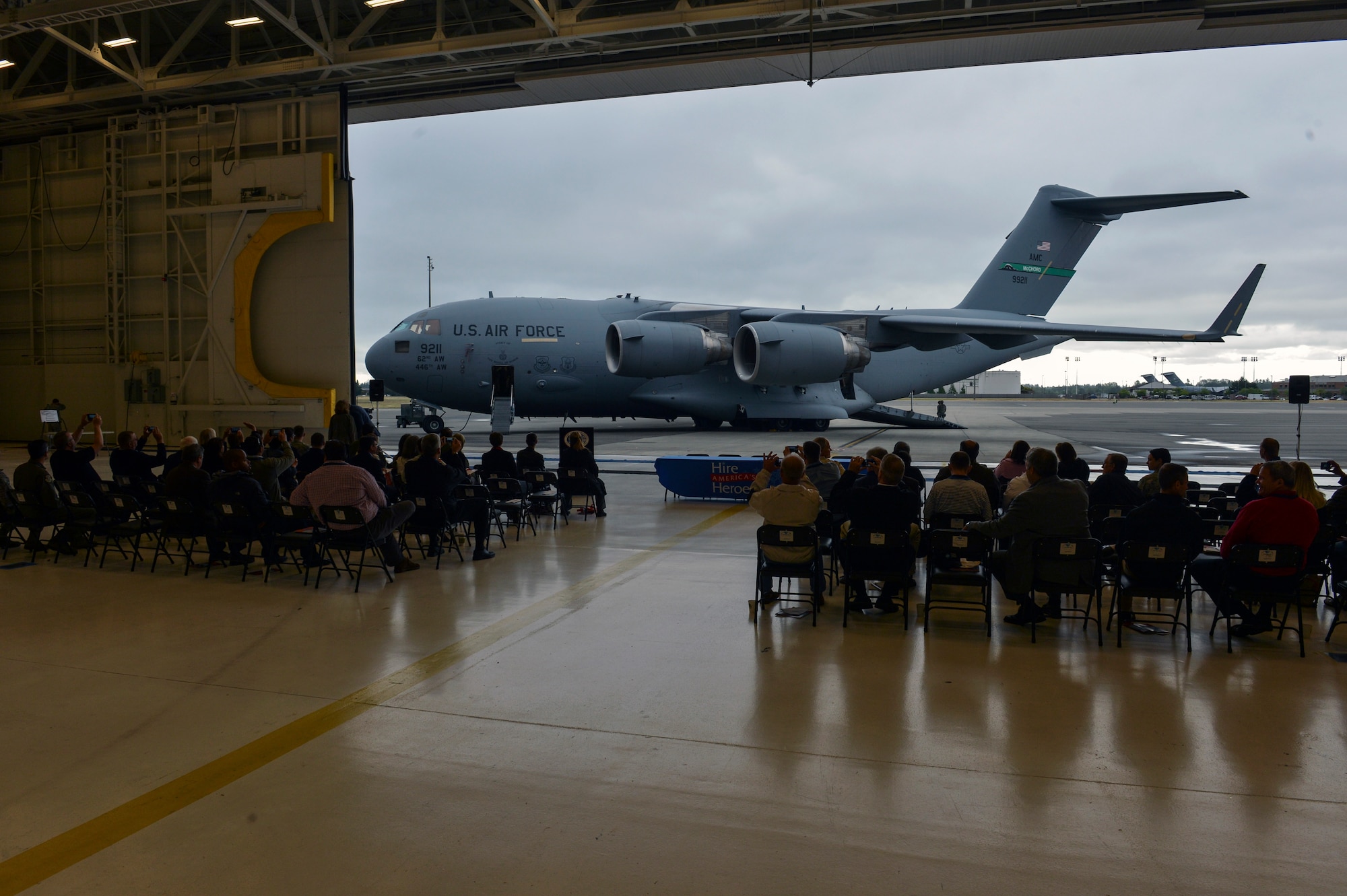 Hangar 9 doors open to reveal a static C-17 Globemaster III on display to the business representatives at the Hire America’s Heroes Symposium June 20, 2014, at Joint Base Lewis-McChord, Wash. The event included several static displays as well as tours of the Western Air Defense Sector, a fire station, and a “Reverse Career Fair”. (U.S. Air Force photo/Staff Sgt. Russ Jackson)