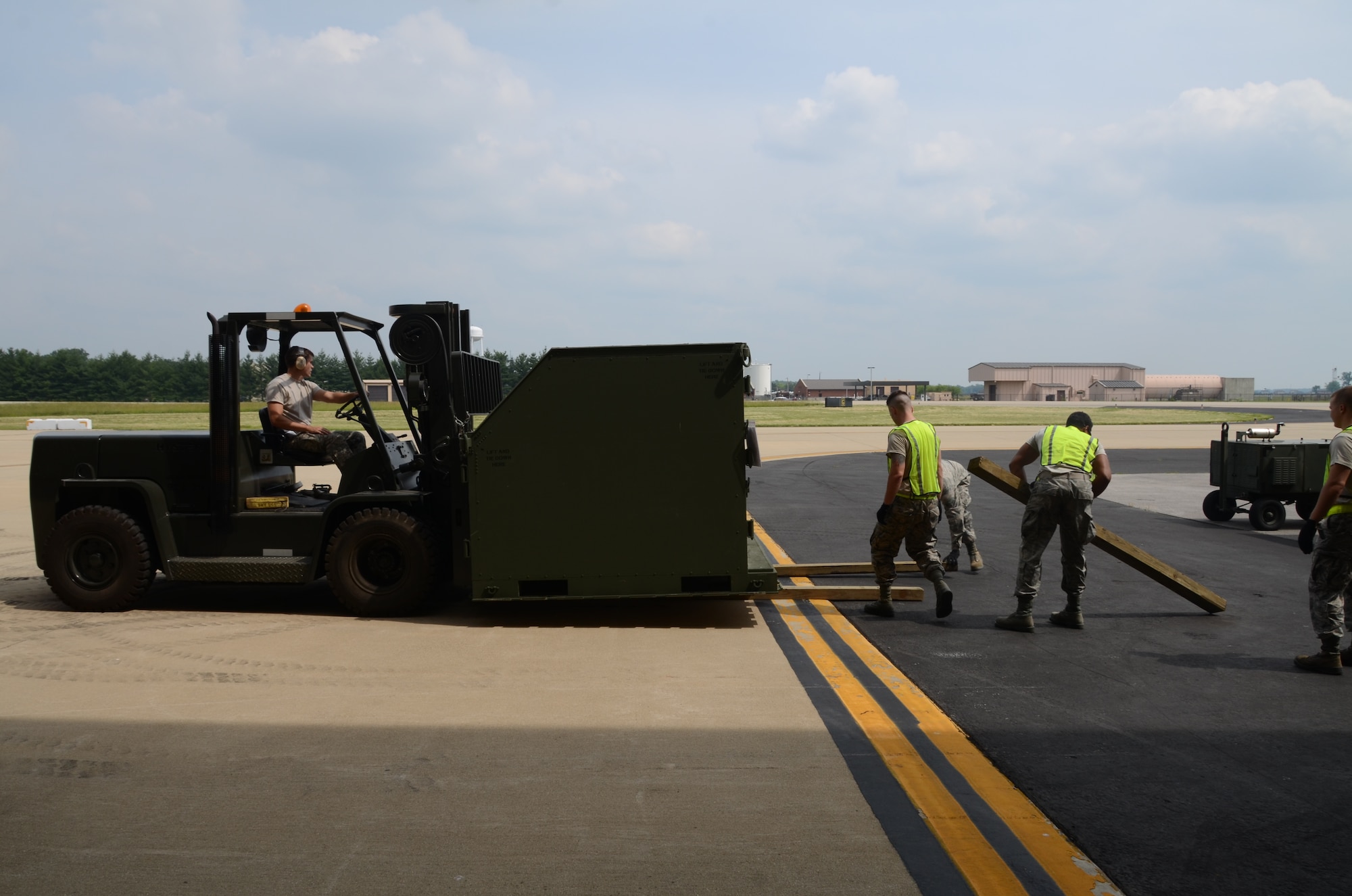 Staff Sgt. Justin Thiessen, a member of the 126th Logistics Readiness Squadron, operates a forklift while moving cargo during an 8010 nuclear mission exercise conducted on Scott Air Force Base, Ill., June 6, 2014. The 126 ARW, an Illinois Air National Guard unit stationed here, supports USSTRATCOM's nuclear global strike and strategic deterrence missions through aerial refueling with the KC-135R Stratotanker to deter regional and strategic threats from adversaries with ground warfare capabilities. (Air National Guard photo by Senior Airman Elise Stout)