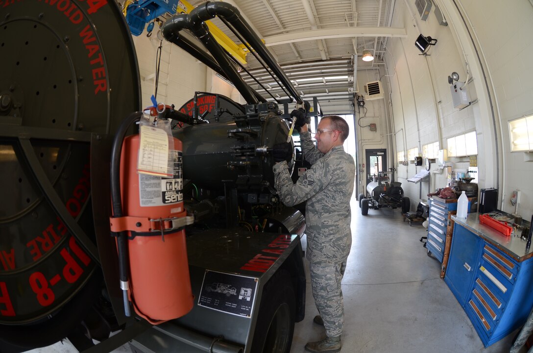 Senior Airman Justin Simpson, a vehicle maintainer for the 126th Logistics Readiness Squadron, torques down the bolts on the fuel tank after a simulated fuel spill during the 8010 nuclear mission exercise conducted on Scott Air Force Base, Ill., June 6, 2014. The 126 ARW, an Illinois Air National Guard unit stationed at Scott Air Force Base, Ill., supports USSTRATCOM's nuclear global strike and strategic deterrence missions through aerial refueling with the KC-135R Stratotanker to deter regional and strategic threats from adversaries with ground warfare capabilities. (Air National Guard photo by Senior Airman Elise Stout)