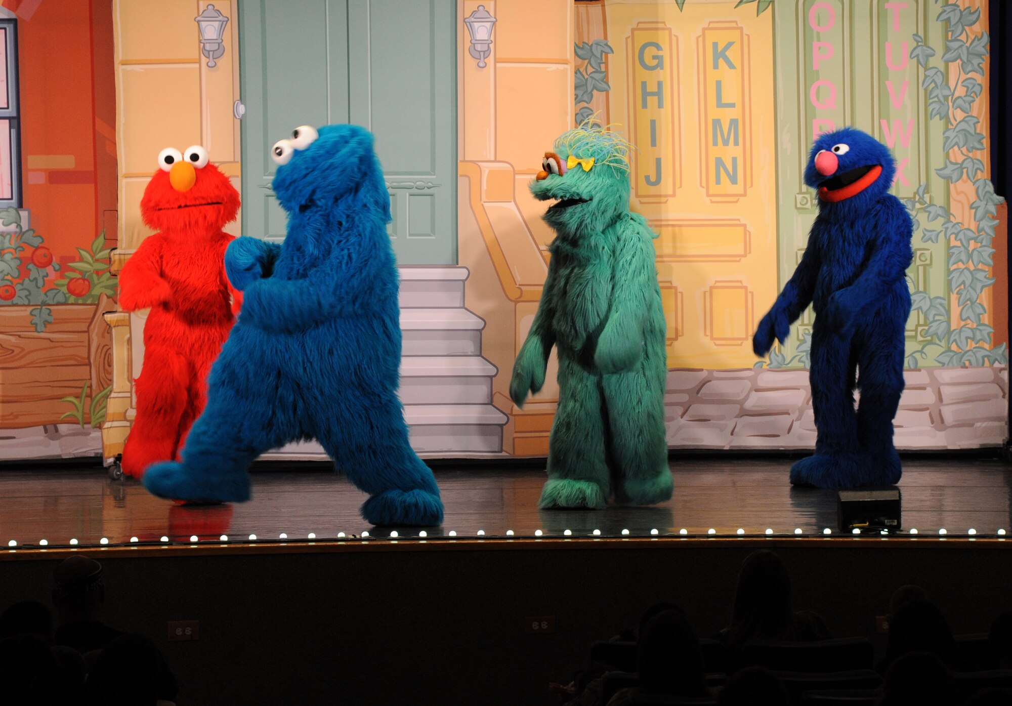 Sesame Street characters dance and sing for military children during the Sesame Street/USO Experience for Military Families June 20 at the Malmstrom Air Force Base auditorium. Children got to see some of their favorite Sesame Street characters such as Elmo, Cookie Monster, Grover, Rosita and also got the opportunity to see Katie, who is a military child herself. (U.S. Air Force photo/Airman 1st Class Joshua Smoot)
