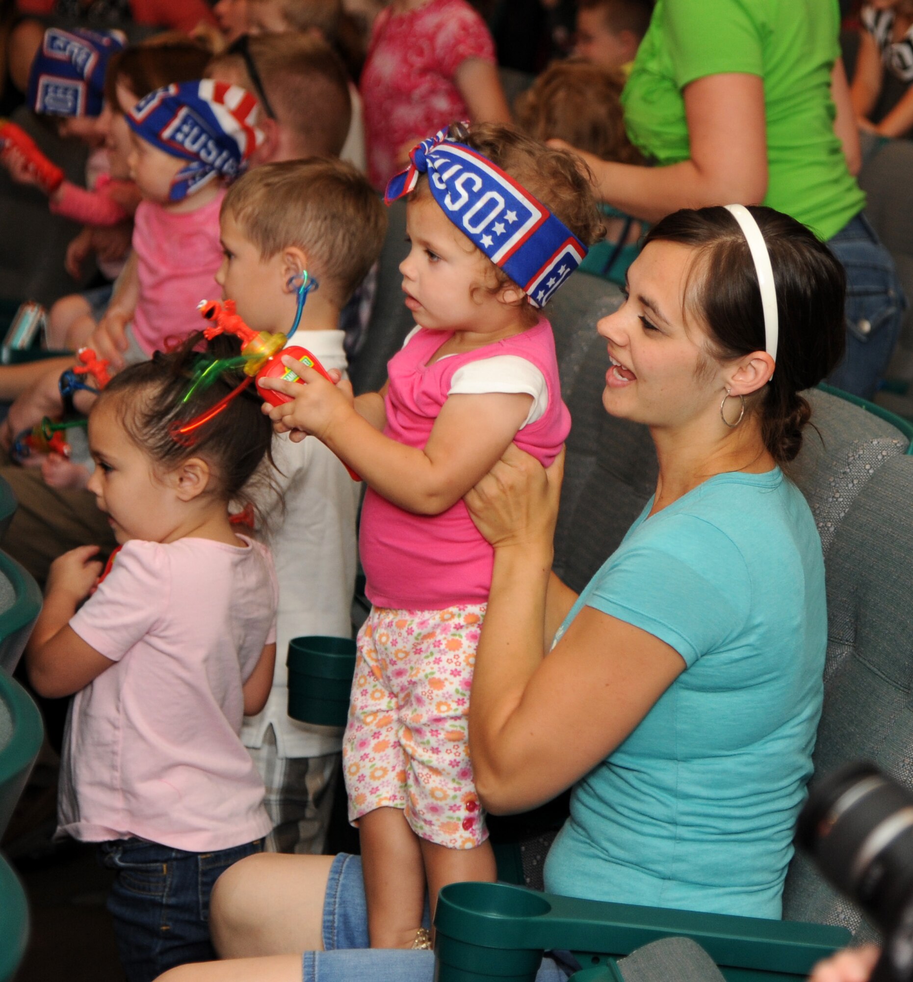 Children and their families dance and sing along with Sesame Street characters during the Sesame Street/USO Experience for Military Families June 20 at the Malmstrom Air Force Base auditorium. Children got to see some of their favorite Sesame Street characters, such as Elmo and Cookie Monster. (U.S. Air Force photo/Airman 1st Class Joshua Smoot)