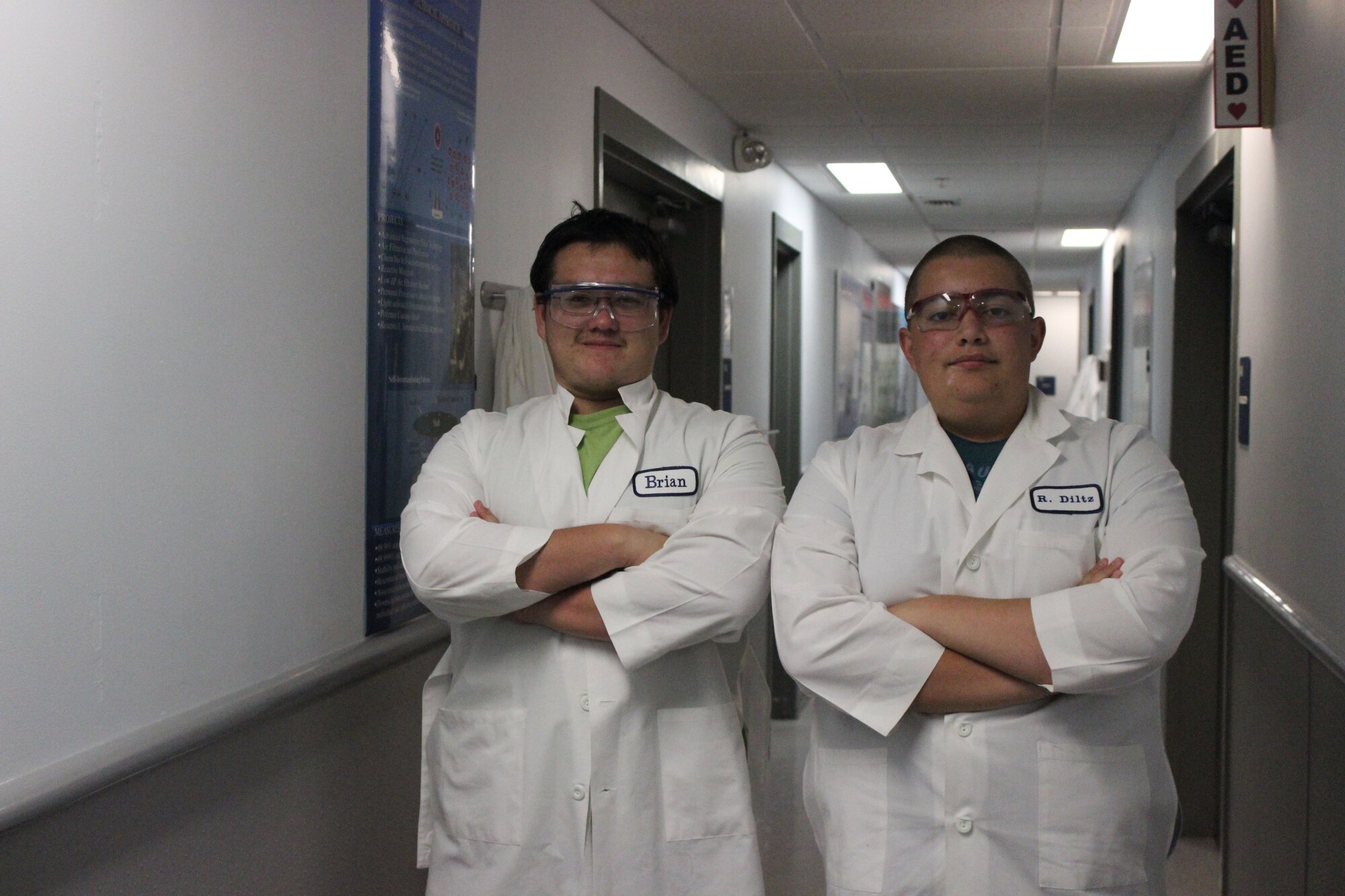 Port St. Joe High School, Fla., students Keith Wadleigh (right) and Bailey Amison show off their borrowed personal protective equipment they wear to work in the Air Force Civil Engineer Center’s laboratory at Tyndall Air Force Base, Fla. The students participated in the Florida STEM Scholars Summer Challenge by working on research projects with AFCEC scientists and engineers. (U.S. Air Force photo/Amy Ausley)