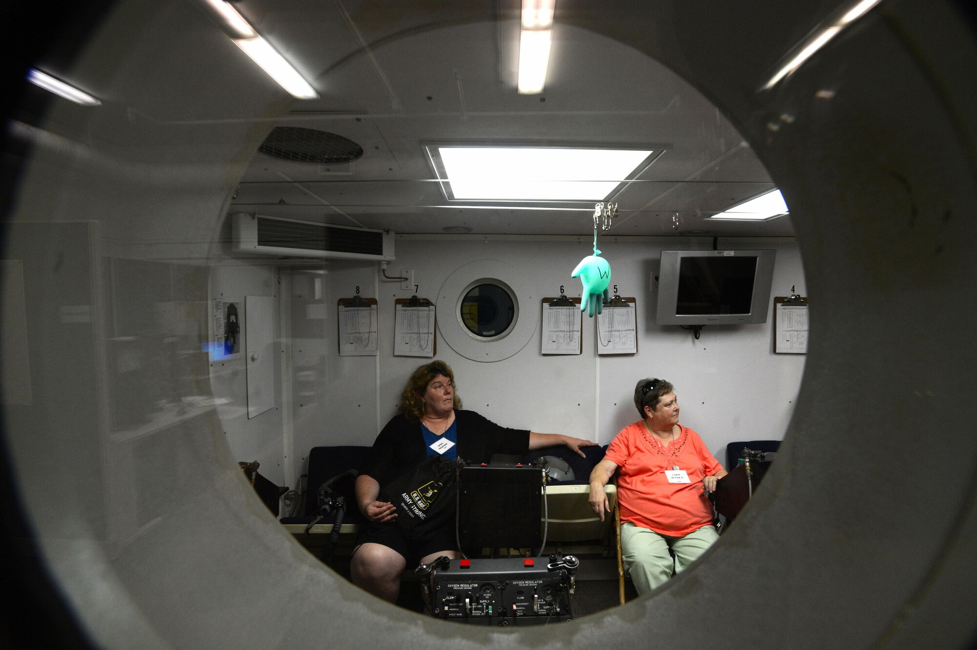 Two South Carolina teachers sit in a hyperbaric chamber while learning about the mission at Shaw Air Force Base, S.C., June 19, 2014. During their tour of the base, the approximately 50 teachers learned about the 20th Aerospace Medicine Squadron, to better prepare their students for Air Force careers. (U.S. Air Force photo by Airman 1st Class Jensen Stidham/Released)  