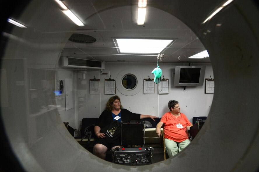 Two South Carolina teachers sit in a hyperbaric chamber while learning about the mission at Shaw Air Force Base, S.C., June 19, 2014. During their tour of the base, the approximately 50 teachers learned about the 20th Aerospace Medicine Squadron, to better prepare their students for Air Force careers. (U.S. Air Force photo by Airman 1st Class Jensen Stidham/Released)  