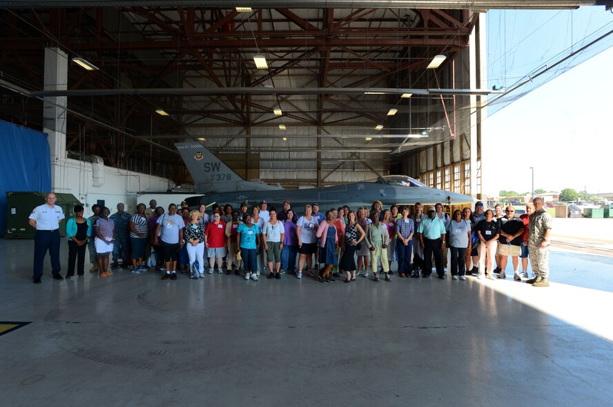 South Carolina school teachers stand in front of an F-16CJ Fighting Falcon at Shaw Air Force Base, S.C., June 19, 2014. The teachers, ranging from grade school to college, received a tour of Shaw AFB to better understand the missions of the Air Force in order to be able to Shaw with their students. (U.S. Air Force photo by Airman 1st Class Jensen Stidham/Released)  