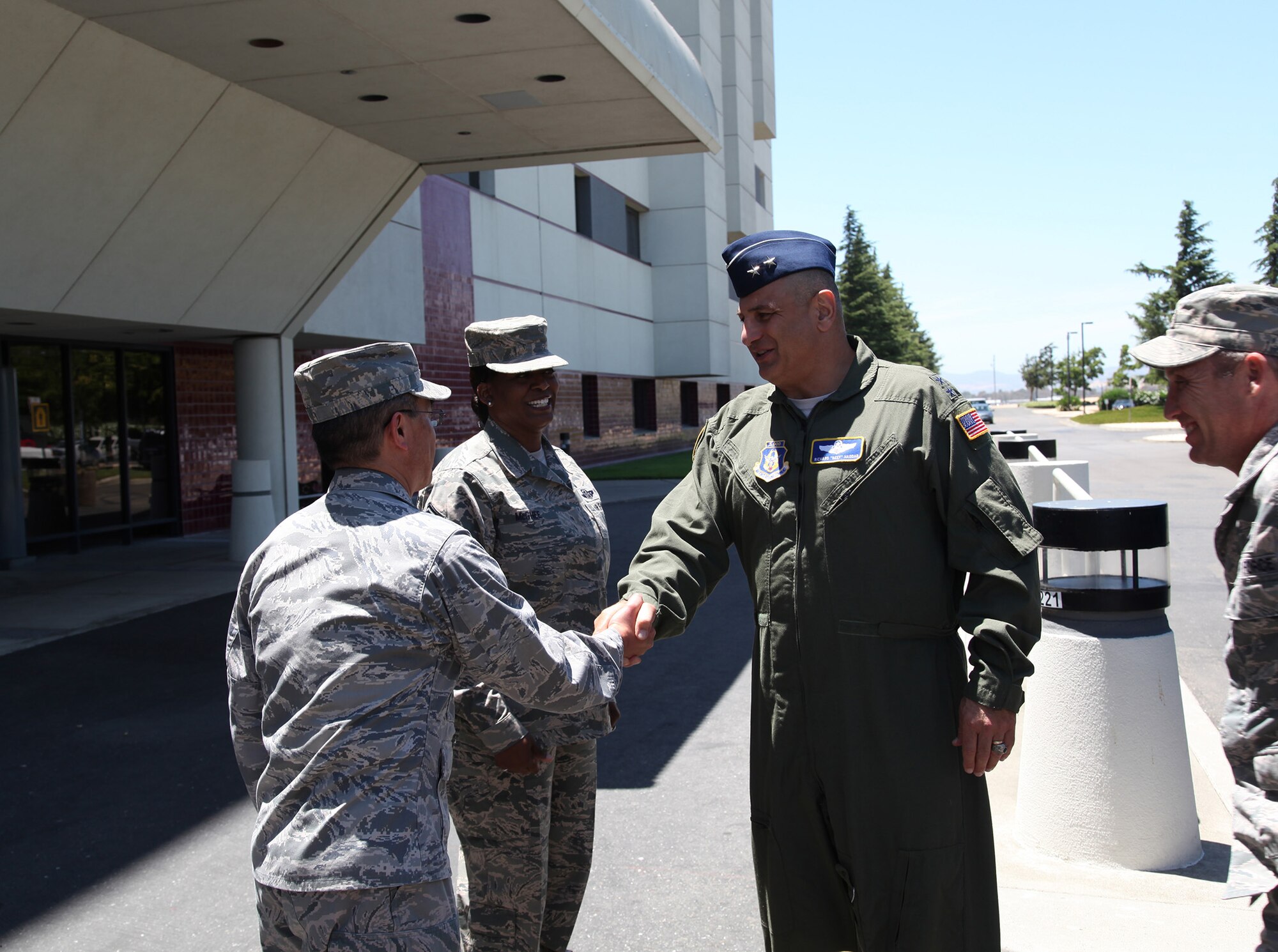 TRAVIS AIR FORCE BASE, Calif. --Leaders of the 349th Aerospace Medicine Squadron welcome Maj. Gen. Richard S. "Beef" Haddad, Vice Commander of the Air Force Reserve Command, to David Grant USAF Medical Center, Travis Air Force Base, Calif., June 21, 2014. From left: Col. Kenneth Furukawa, 349th AMDS commander; and Senior Master Sgt. Helena McGhee, 349th AMDS Senior Air Reserve Technician. The general visited facilities and met with Airman to see air mobility innovations helping Travis AFB personnel deliver America's hope and might around the globe. (U.S. Air Force photo/Lt. Col. Robert Couse-Baker)