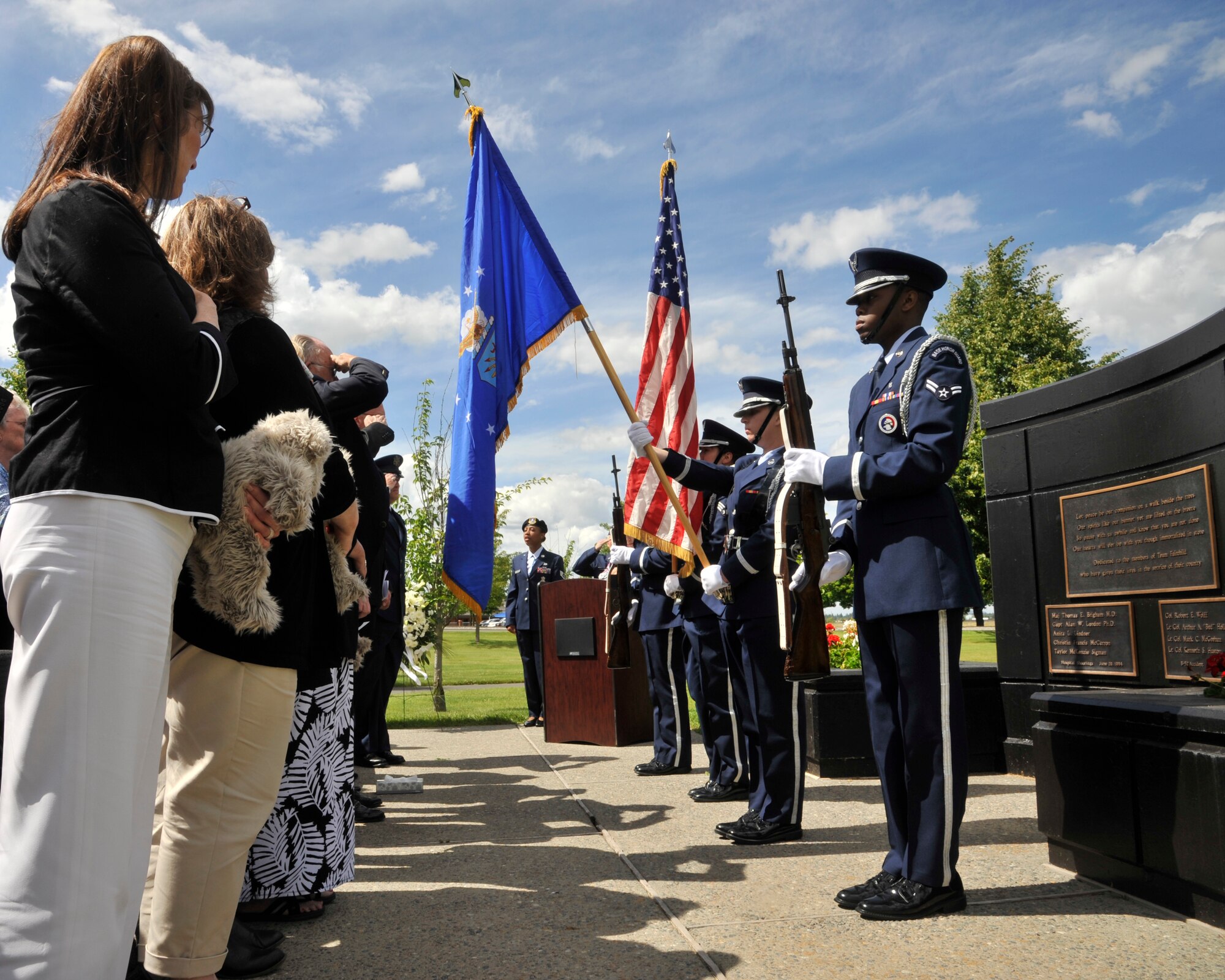 Members of the Team Fairchild Honor Guard present the colors during the national anthem at Fairchild Air Force Base, Wash., June 20, 2014. The 92nd Medical Group hosted a memorial service to commemorate the 20-year-anniversary of the hospital shooting here in 1994. (U.S. Air Force photo by Senior Airman Mary O'Dell/Released)