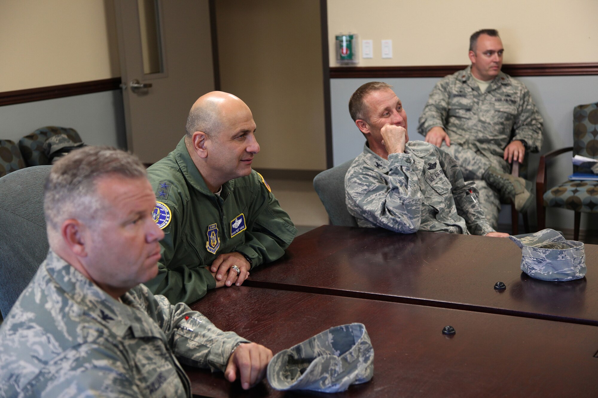 TRAVIS AIR FORCE BASE, Calif. --Col. Patrick T. Williams, Vice Commander of the 349th Air Mobility Wing;  Maj. Gen. Richard S. "Beef" Haddad, Vice Commander of the Air Force Reserve Command; and Col. Matthew J. Burger, Commander of the 349th Air Mobility Wing, listen as Tech. Sgt. Dolores Rodriguez, 349th Aerospace Medicine Squadron, briefs the wing's innovative fitness clinic at David Grant USAF Medical Center, Travis Air Force Base, Calif., June 21, 2014. The clinic streamlines the process for determining medical profiles; ensuring fitness testing is not delayed by administrative requirements. The general visited facilities and met with Airman to see air mobility innovations helping Travis AFB personnel deliver America's hope and might around the globe. (U.S. Air Force photo/Lt. Col. Robert Couse-Baker)