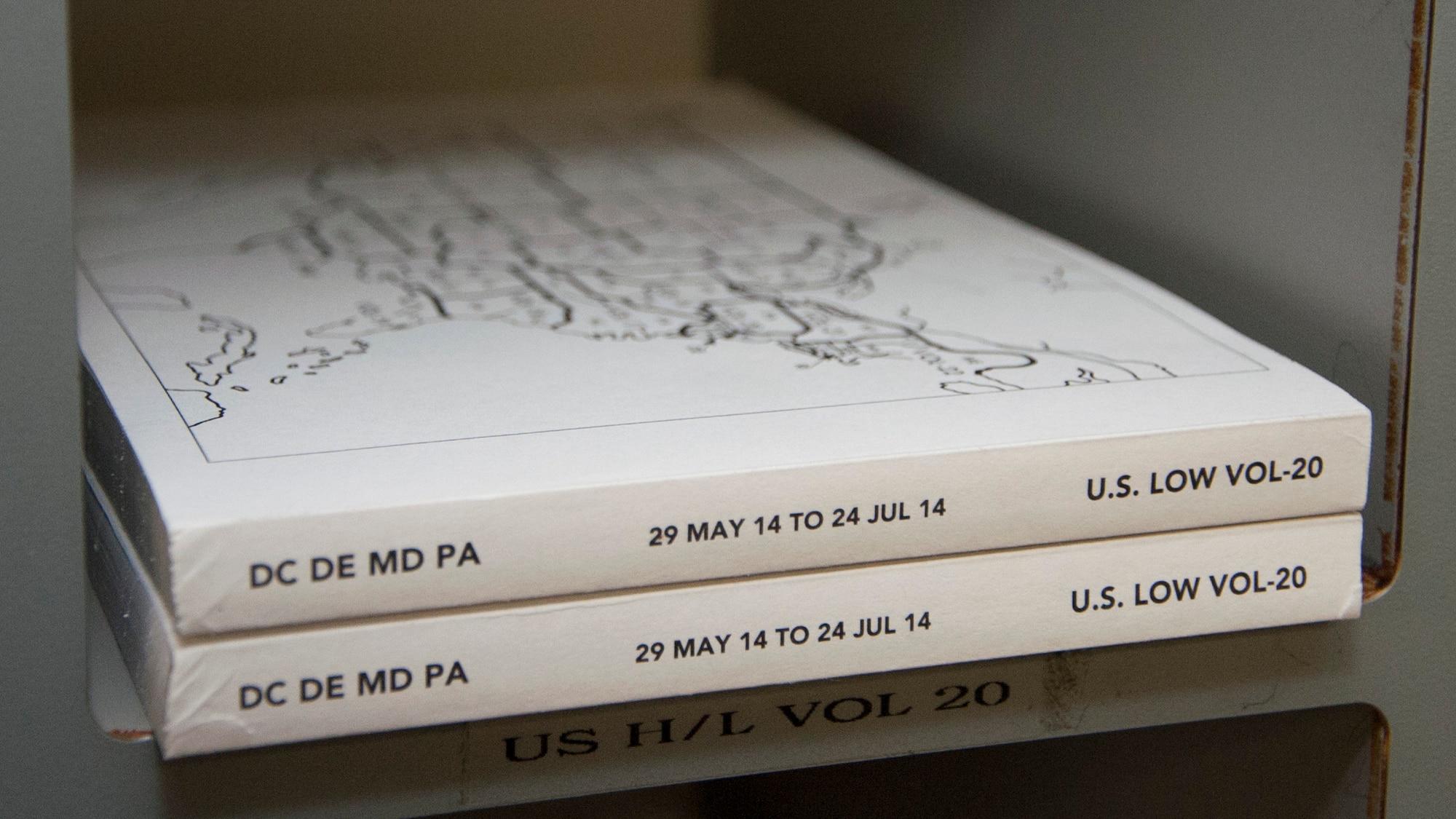 The Washington, D.C., Delaware, Maryland and Pennsylvania flight information publications sit in a cubbyhole June 16, 2014, on Dover Air Force Base, Del. These publications contain information about the DC, DE, MD and PA area’s airports; such as frequencies, hours of operation and who is in charge of the airport. (U.S. Air Force photo/Senior Airman Jared Duhon)