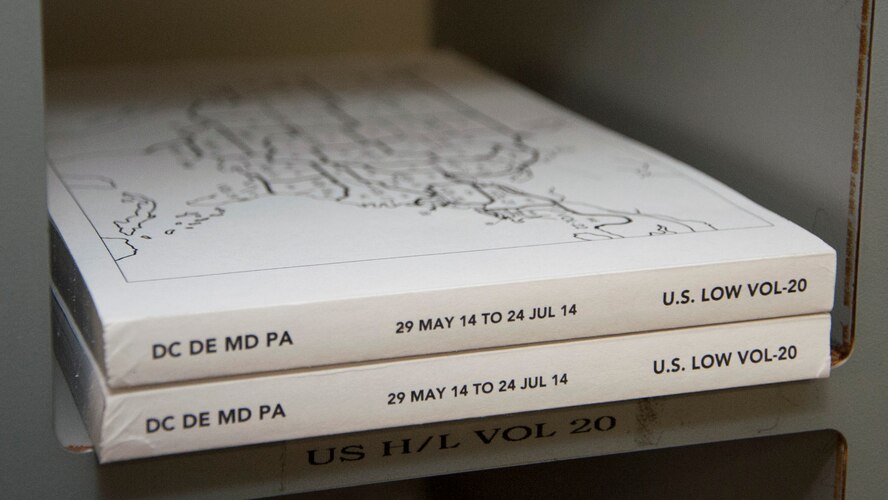 The Washington, D.C., Delaware, Maryland and Pennsylvania flight information publications sit in a cubbyhole June 16, 2014, on Dover Air Force Base, Delaware. These publications contain information about the DC, Delaware, Maryland and Pennsylvania area’s airports; such as frequencies, hours of operation and who is in charge of the airport. (U.S. Air Force photo/Senior Airman Jared Duhon) 

