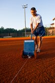 Staff Sgt. Lakan Ello, 628th Force Support Squadron fitness specialist, uses a chalk dispenser to put down a boundary line June 18, 2014, at Joint Base Charleston, S.C. New chalk lines are put down every game day to keep the field maintained for the players. (U.S. Air Force photo/Senior Airman George Goslin)