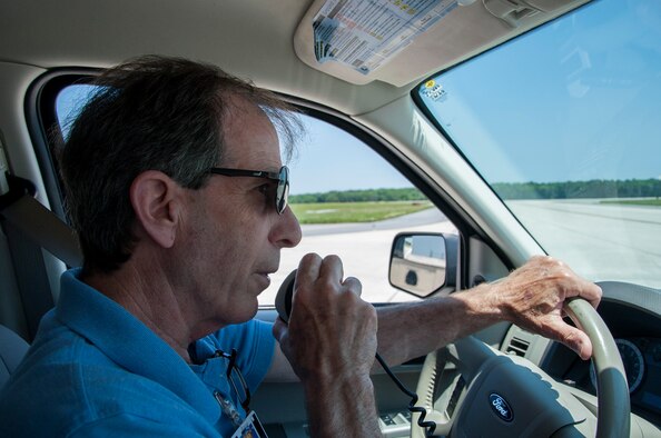 Mike Georgules, 436th Operations Support Squadron airfield management shift leader, requests access to the runway with the air traffic control tower, June 16, 2014, on Dover Air Force Base, Del. Airfield management is in charge of ensuring the runway and attached surface area is operational. (U.S. Air Force photo/Senior Airman Jared Duhon)