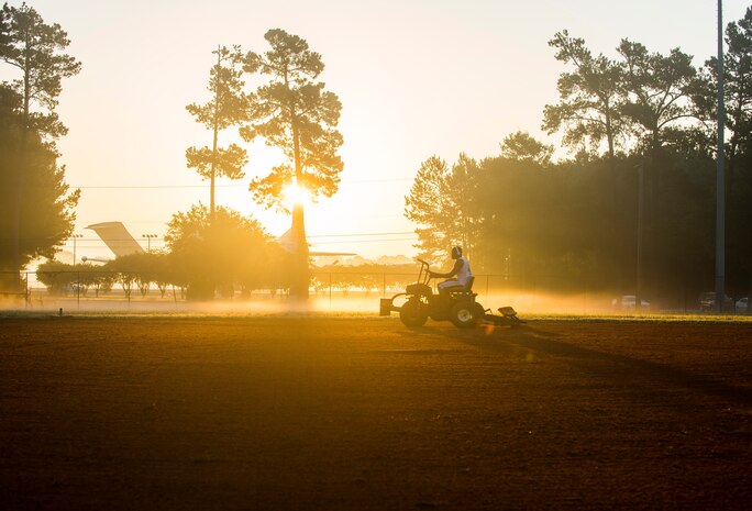 Staff Sgt. David Johnson, 628th Force Support Squadron sports program director, rakes the infield, June 18, 2014, at Joint Base Charleston, S.C. The infields are raked and the bases are cleaned after being watered to prepare for the day's game. (U.S. Air Force photo/Senior Airman George Goslin)