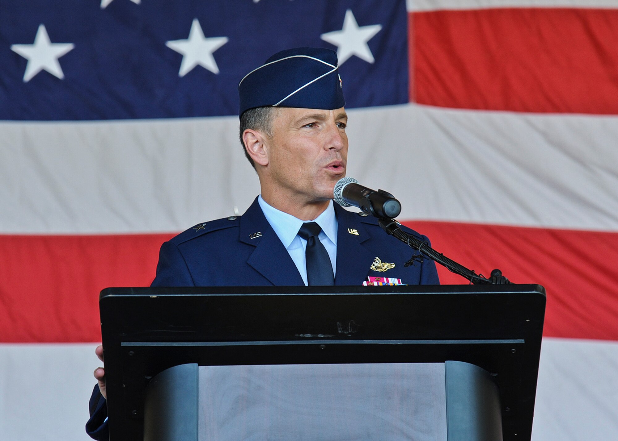 Brig. Gen. Scott Pleus, 56th Fighter Wing commander, speaks to the audience after assuming command of the wing at a ceremony on Luke Air Force Base on June 20. Pleus commissioned in 1989 through the Air Force ROTC program at the University of Minnesota-Duluth. This is his second tour as a wing commander, having previously commanded the 8th Fighter Wing at Kunsan Air Base, Korea, from 2011-2012. (U.S. Air Force photo/Staff Sgt. Darlene Setlmann)