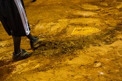 Staff Sgt. David Johnson, 628th Force Support Squadron sports program director, fixes holes and divots around home plate, June 18, 2014, at Joint Base Charleston, S.C. The fields are watered to soften them up to give players more traction and prevent injury. (U.S. Air Force photo/Senior Airman George Goslin)
