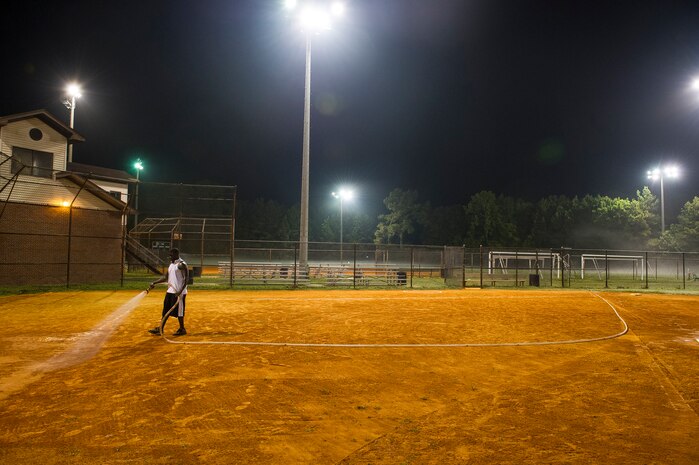 Staff Sgt. David Johnson, 628th Force Support Squadron sports program director, waters an infield, June 18, 2014, at Joint Base Charleston, S.C. The fields are watered to soften them up to give players more traction and prevent injury. (U.S. Air Force photo/Senior Airman George Goslin)